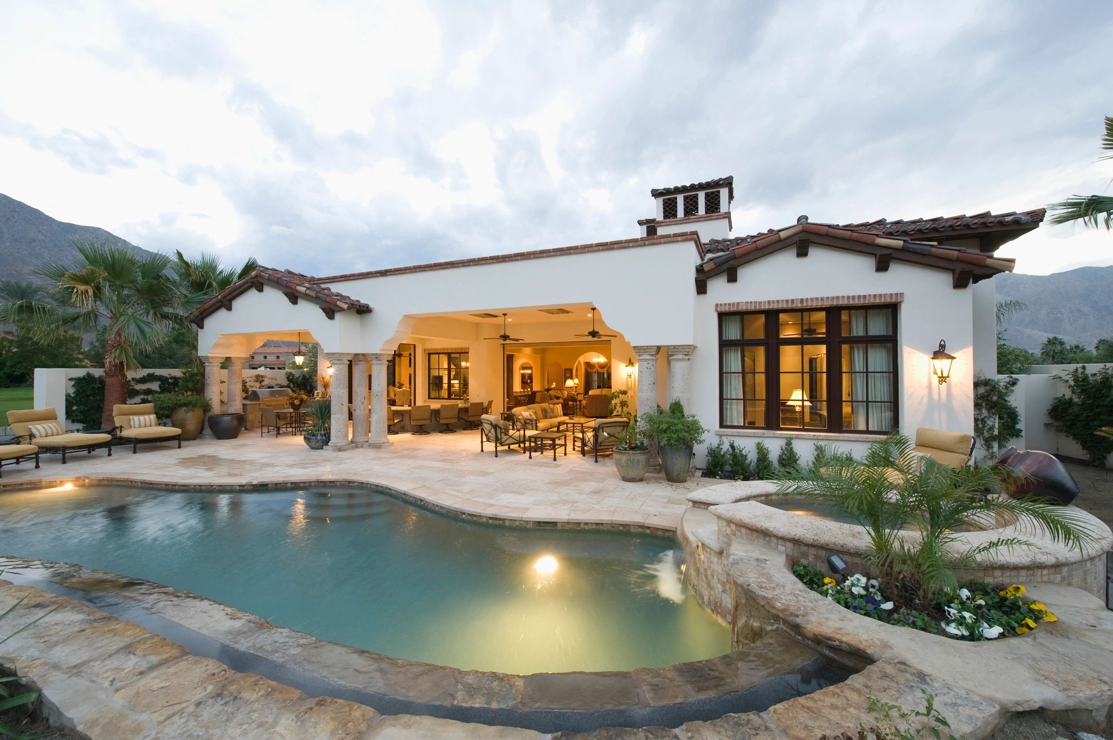 Spanish-style home with pool and patio at dusk - Premier Advantage Real Estate, flat fee listing bro